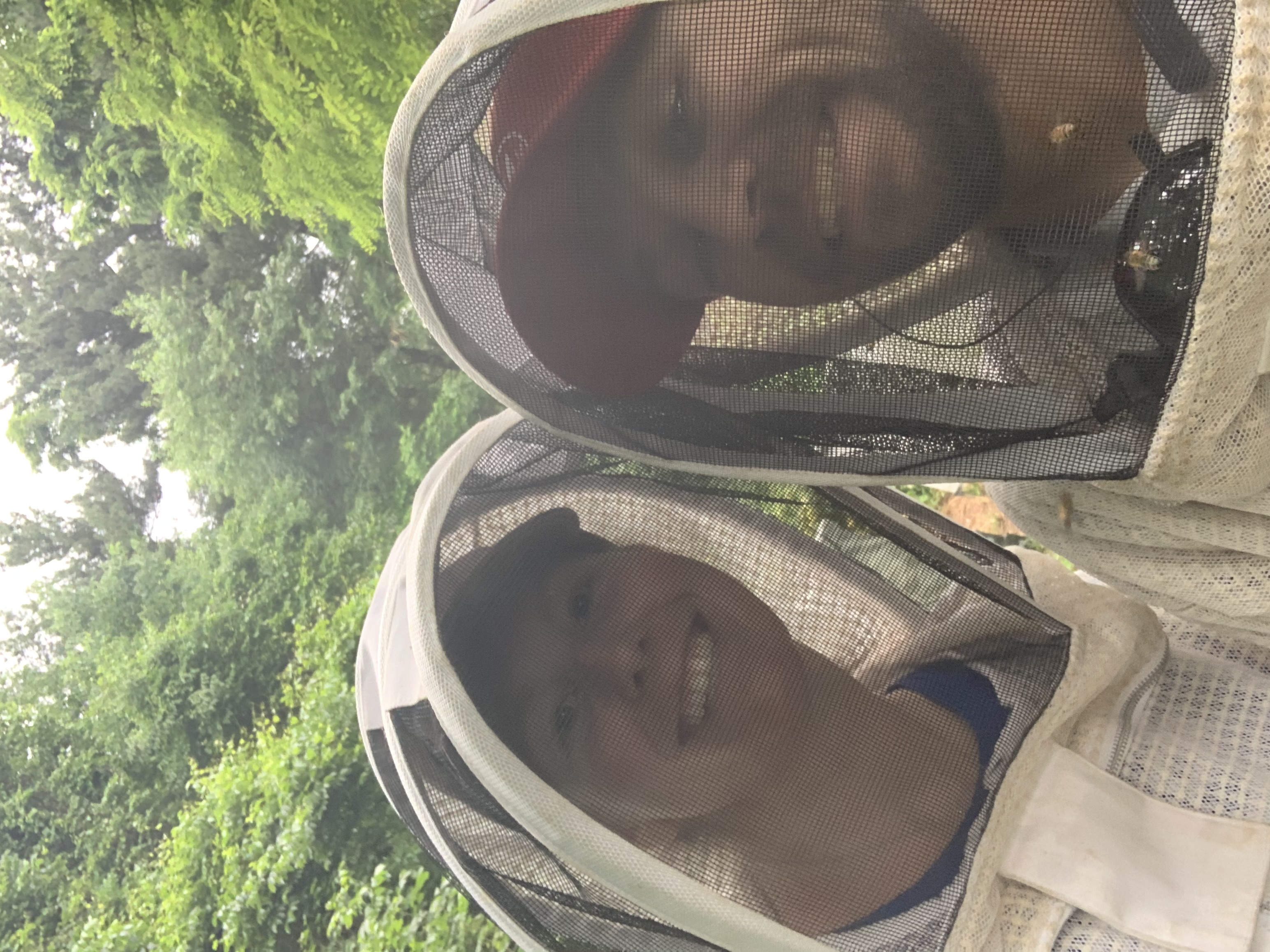 Devon and Elyse Alleman suited up and working the hives — the beekeeping experience offered to Honey House guests