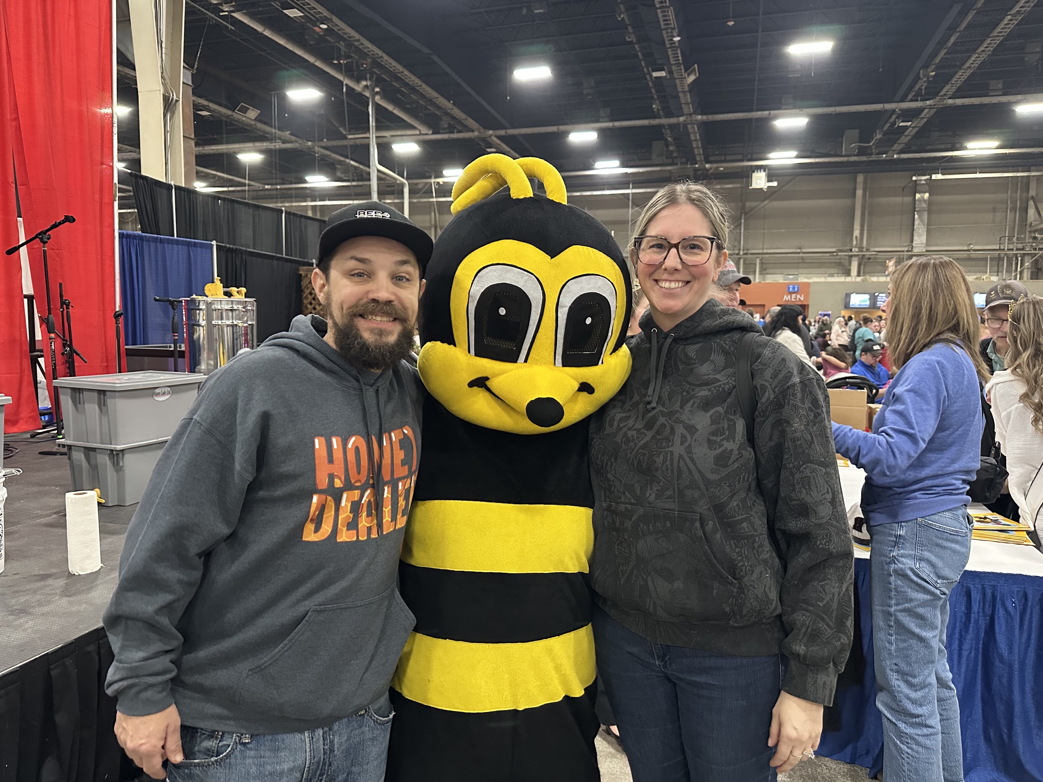Devon and Elyse Alleman at the PA Farm Show in Harrisburg with someone in a bee costume